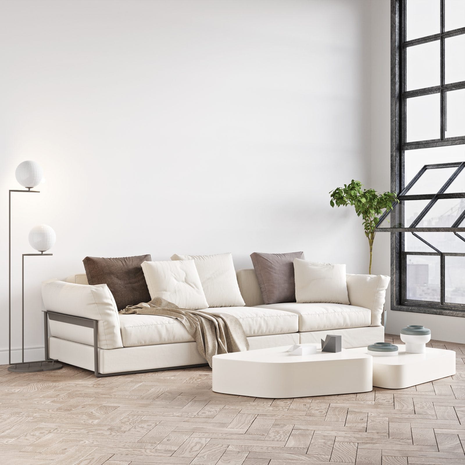 Beautiful interior of a modern room. Bright and clean design. A sofa standing by a large window against a wall background.